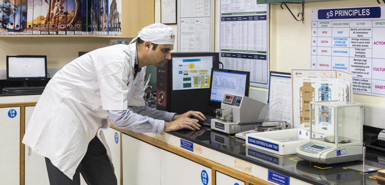 Quality control laboratory with technician working